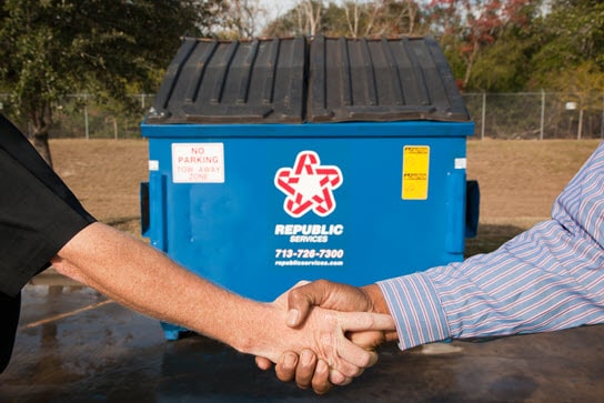 Handshake in front of dumpster