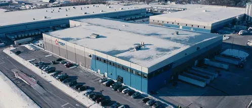 truck dumping recyclables onto the ground in a warehouse