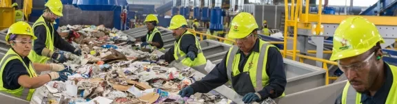 workers sorting recycling on a conveyer belt